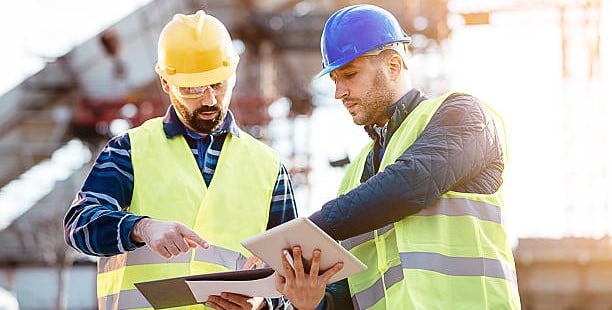 Construction Workers Using Quality Control Software in the Field